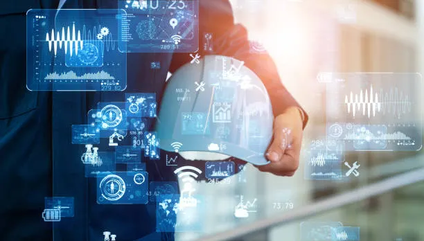 Hand holding safety helmet surrounded by factory automation and digital transformation data graphics
